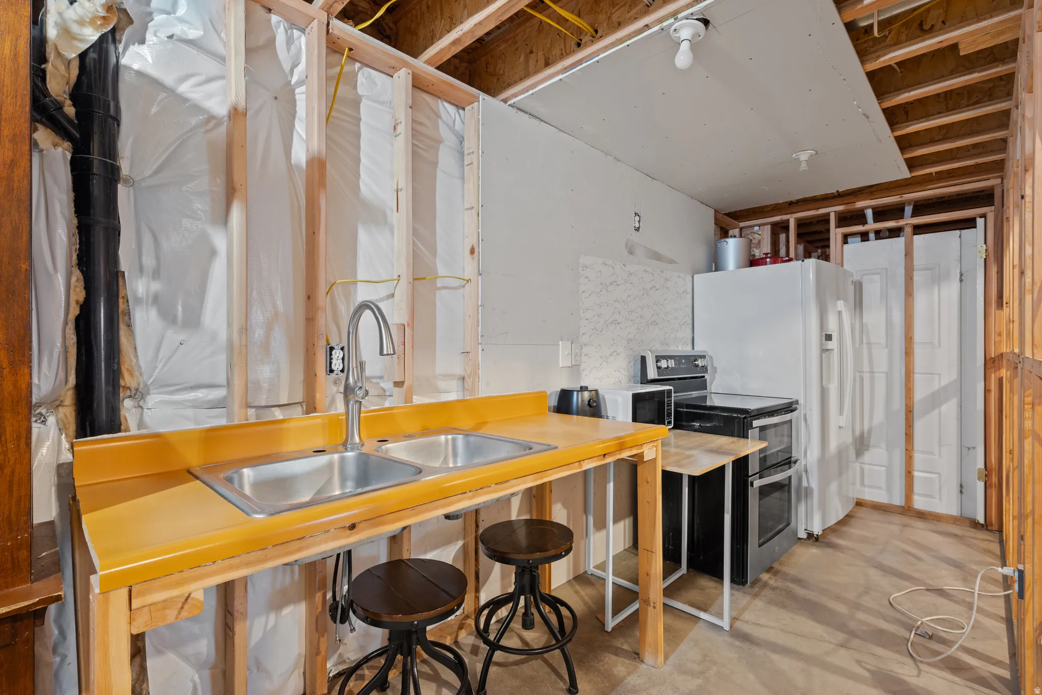 Galley kitchen area with a double basin stainless steel sink and a contemporary faucet