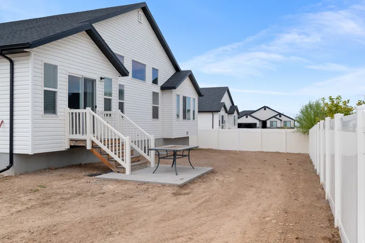 White vinyl siding exterior with black trim accents and a dark shingled roof