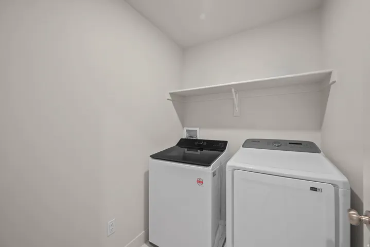 Dedicated laundry area with a white wall-mounted shelf