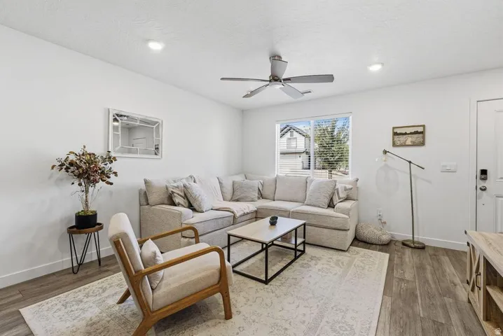Recessed lighting, wood-finish flooring, ceiling fan, and a light-filled window