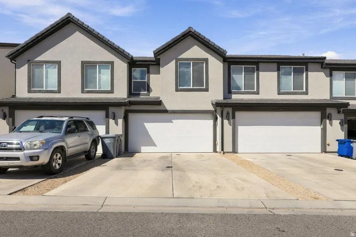 Multi-unit exterior with stucco finish and dark trim