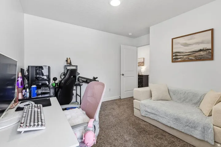 Neutral wall color, recessed ceiling lighting, and carpet flooring