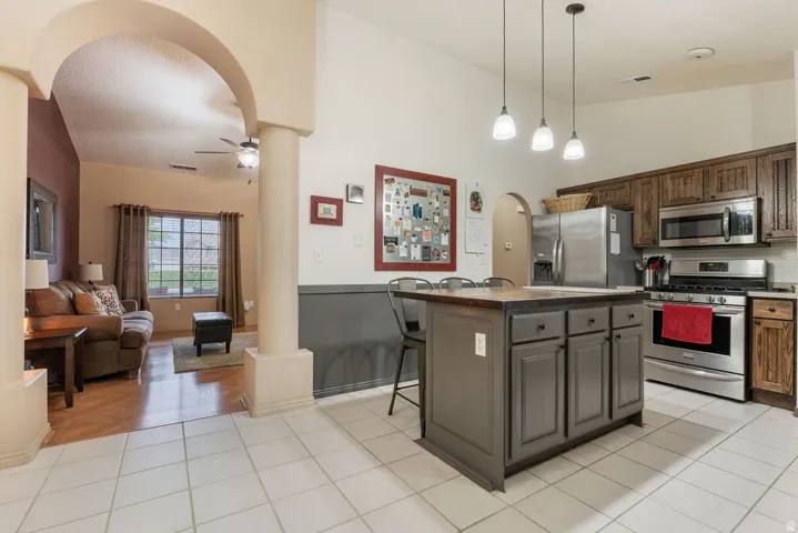 Kitchen featuring a center island with seating, stainless steel appliances, and pendant lighting