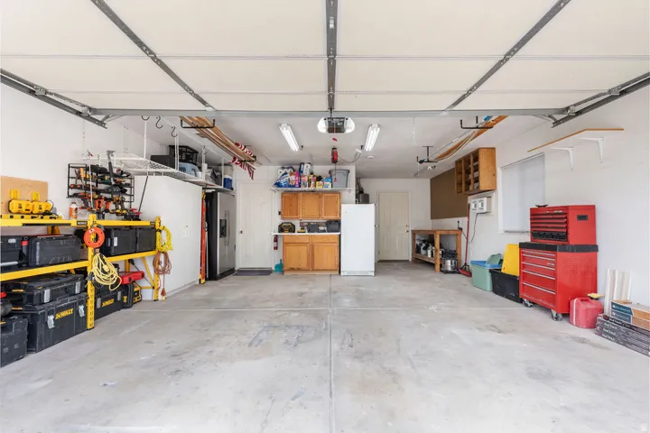 Spacious garage featuring concrete flooring and integrated overhead lighting