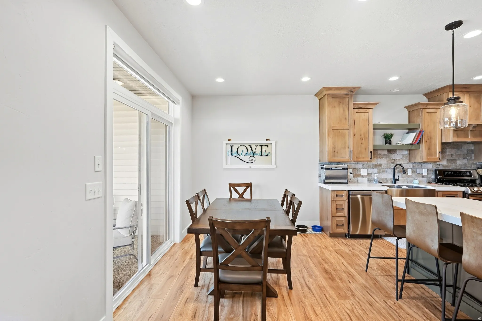 Wood-finish flooring throughout, with a sliding glass door providing access to the exterior