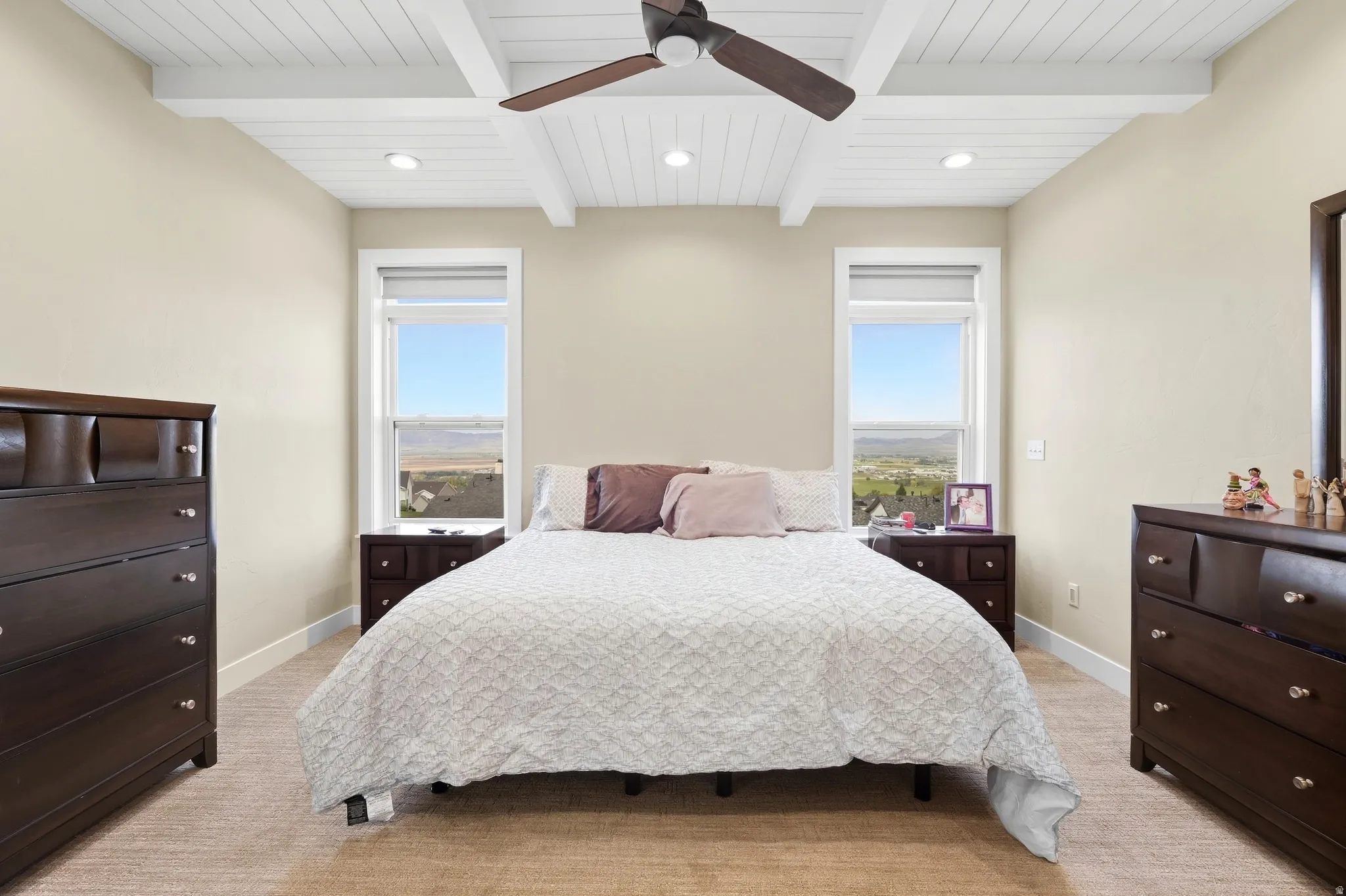 Vaulted ceiling with exposed beams and recessed lighting