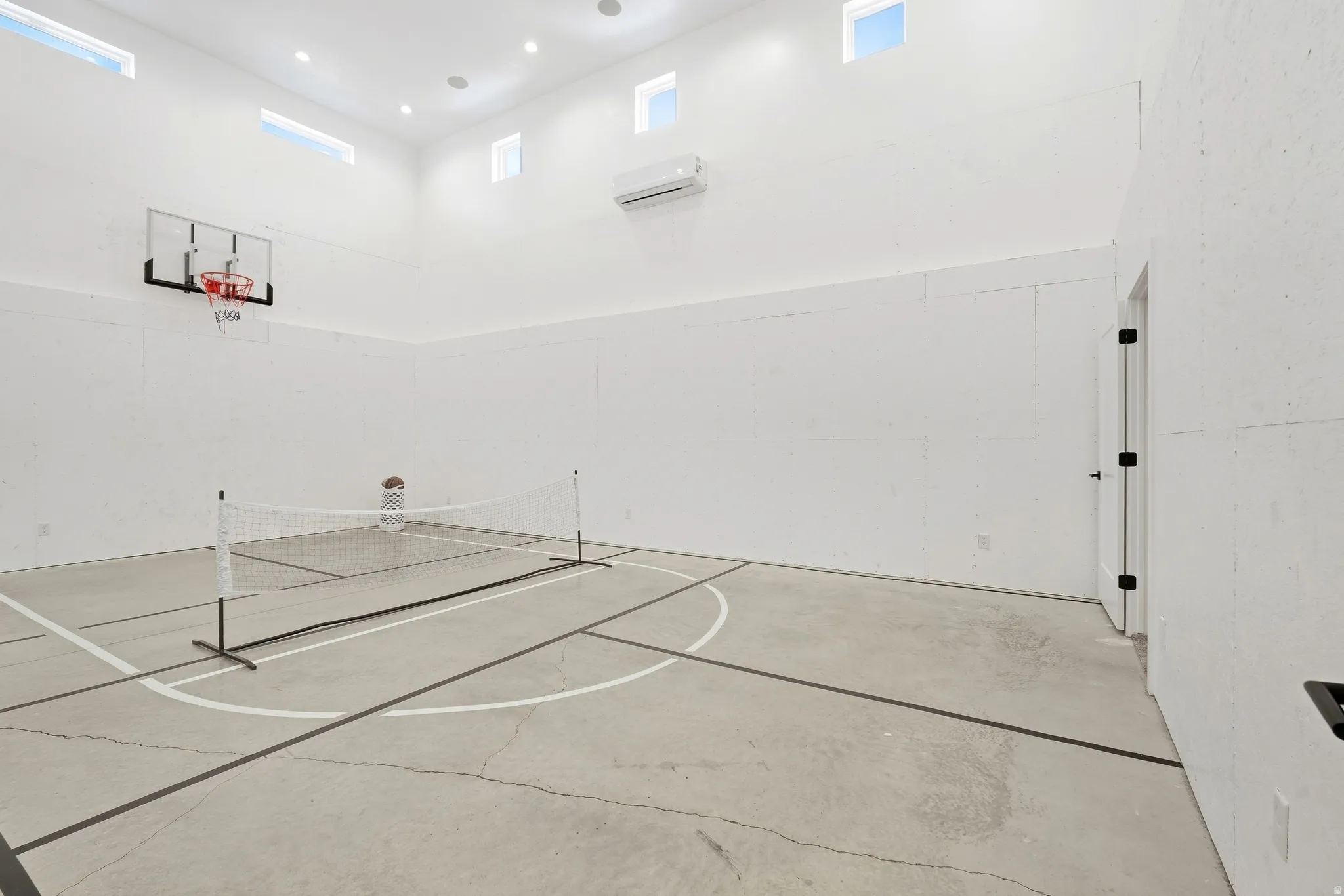 Indoor court featuring concrete flooring with court markings