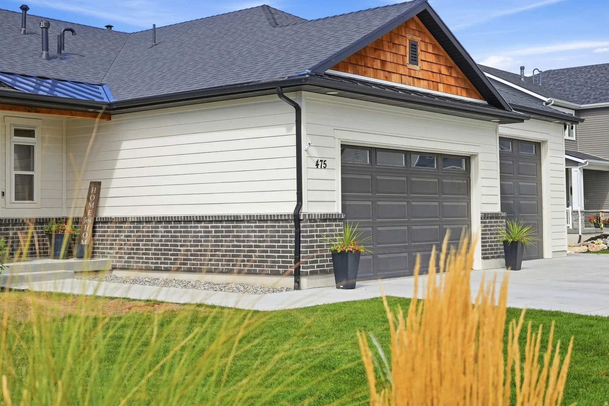 Two-car garage with dark gray doors and upper window panels
