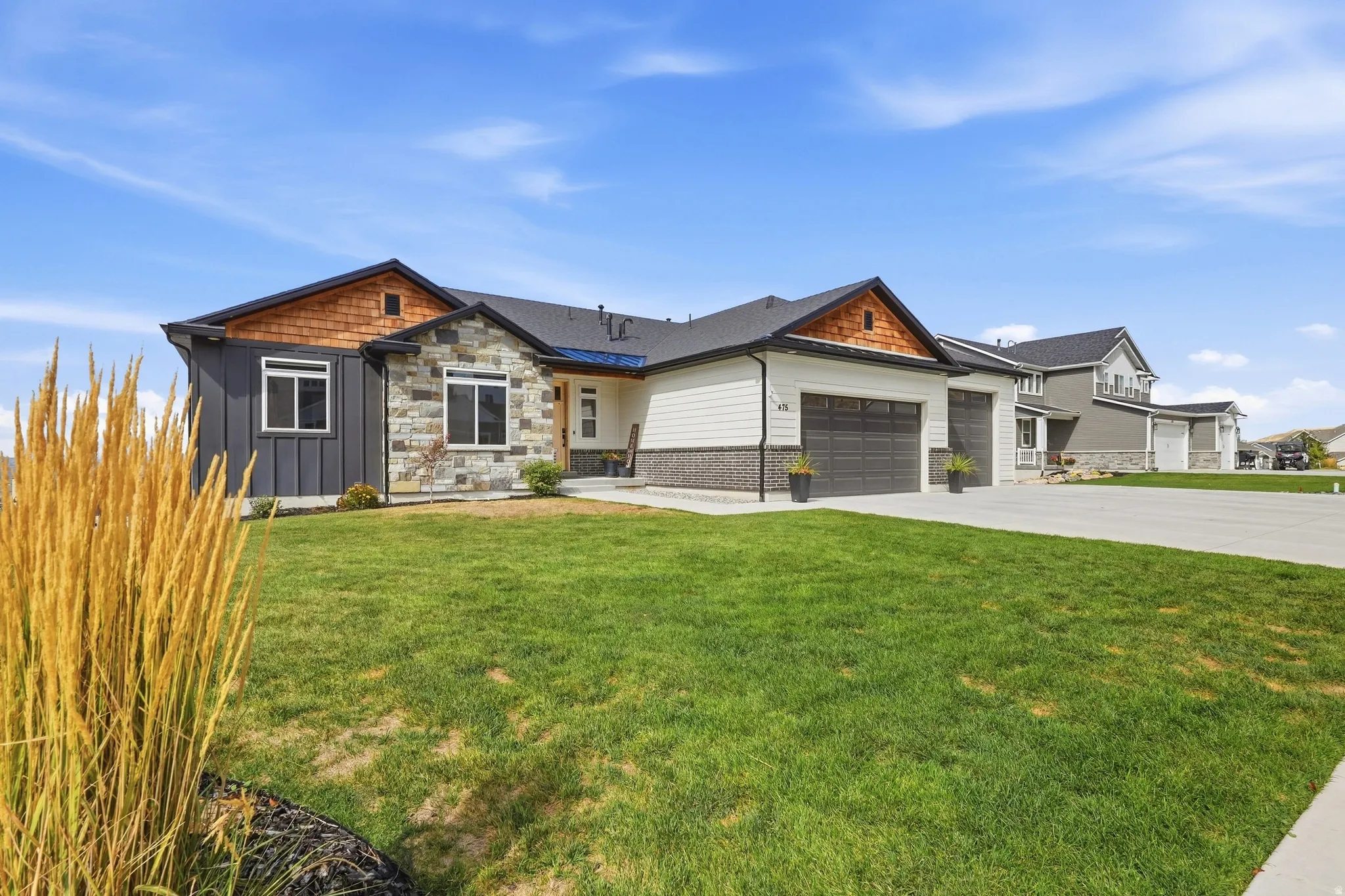 Multi-textured facade with stone, vertical siding, and horizontal siding