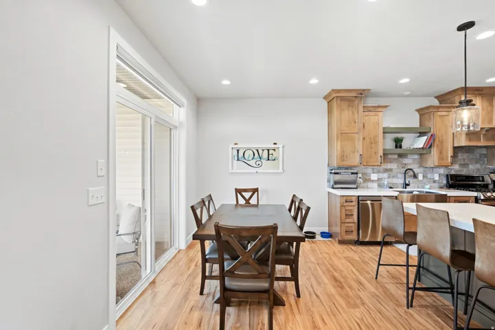 Wood-finish flooring throughout, with a sliding glass door providing access to the exterior