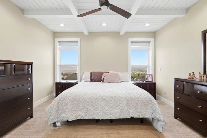 Vaulted ceiling with exposed beams and recessed lighting
