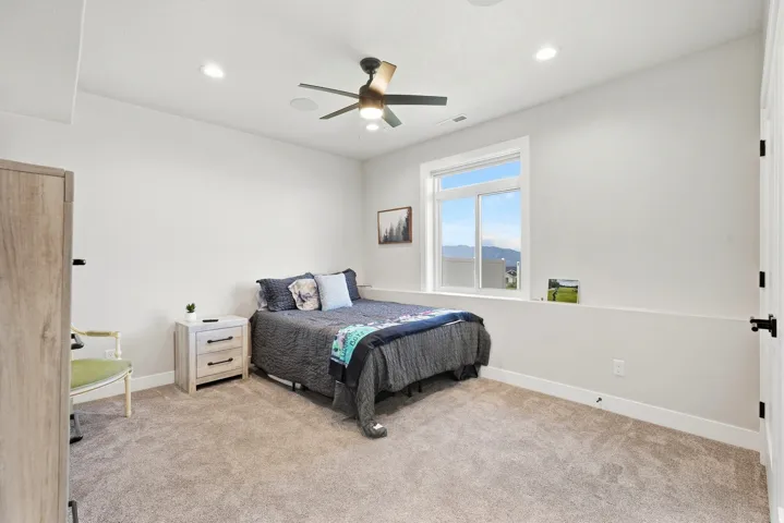 Recessed lighting, ceiling fan, and carpeted flooring