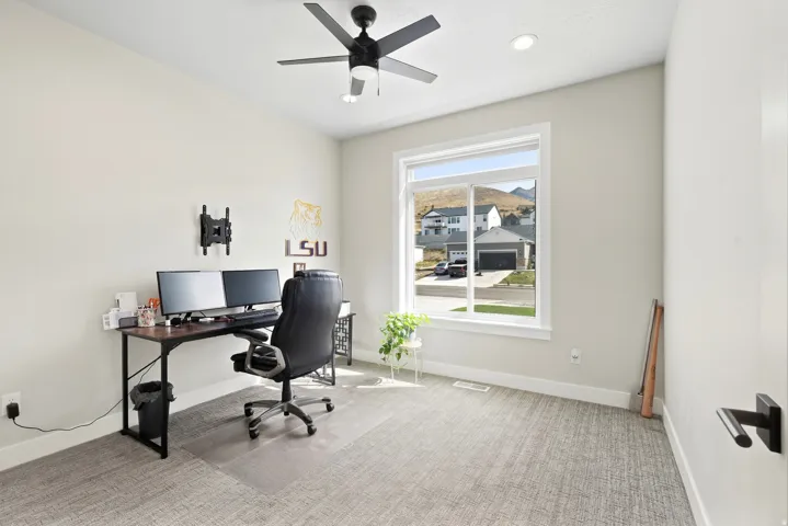 Spacious room with light-colored walls and patterned carpeting