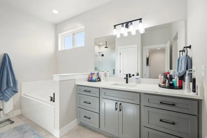 Dual-sink vanity with gray cabinetry and white countertop