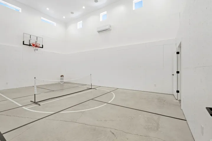 Indoor court featuring concrete flooring with court markings