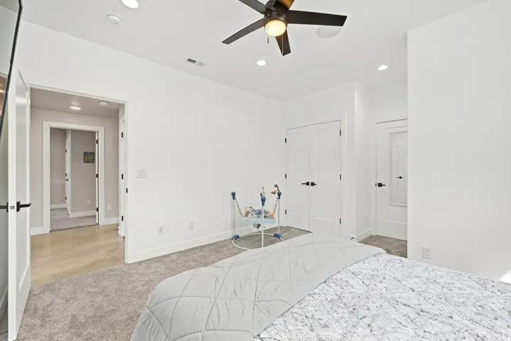 Recessed lighting, ceiling fan, and carpeted flooring
