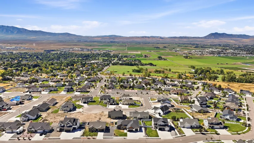 New construction homes within a residential community, featuring paved streets and established landscaping