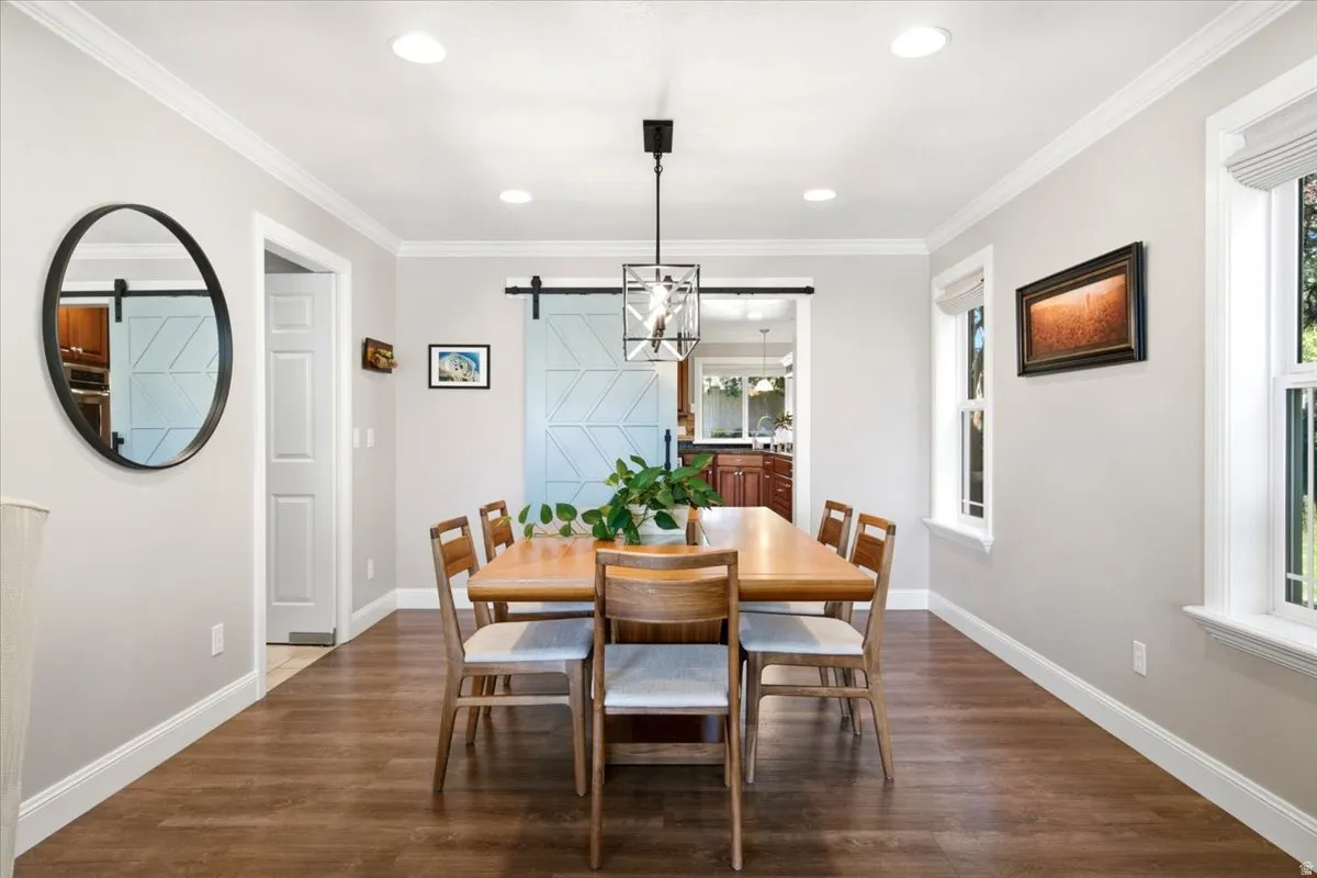 Recessed lighting illuminates wood-finish flooring and crown molding