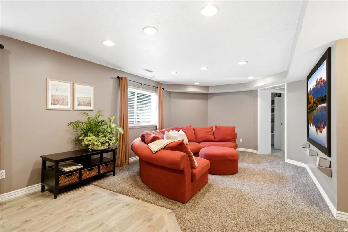 Recessed lighting, wood-finish flooring, and carpeted areas