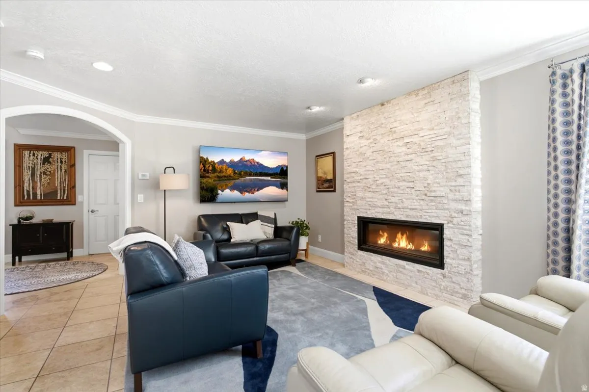 Recessed lighting, crown molding, and an arched doorway