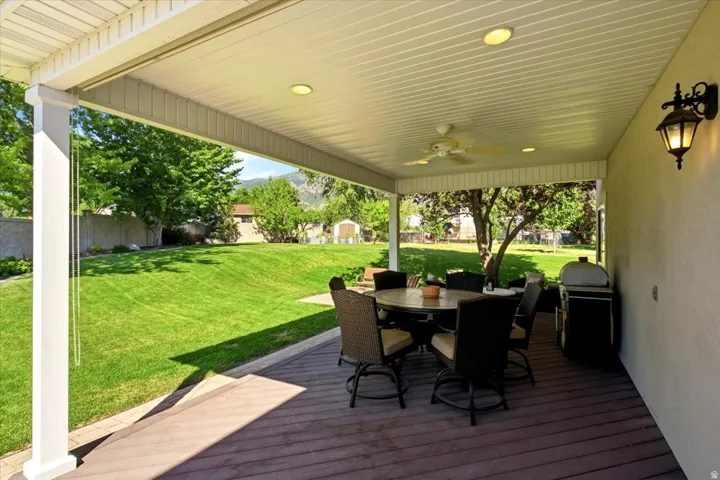 Covered patio featuring a ceiling fan, recessed lighting, and wall-mounted exterior light fixture