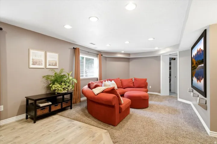 Recessed lighting, wood-finish flooring, and carpeted areas