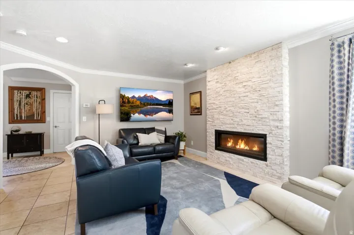 Recessed lighting, crown molding, and an arched doorway
