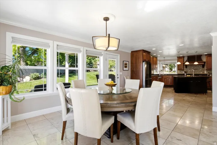 Spacious dining area with tile flooring and a multi-light pendant fixture