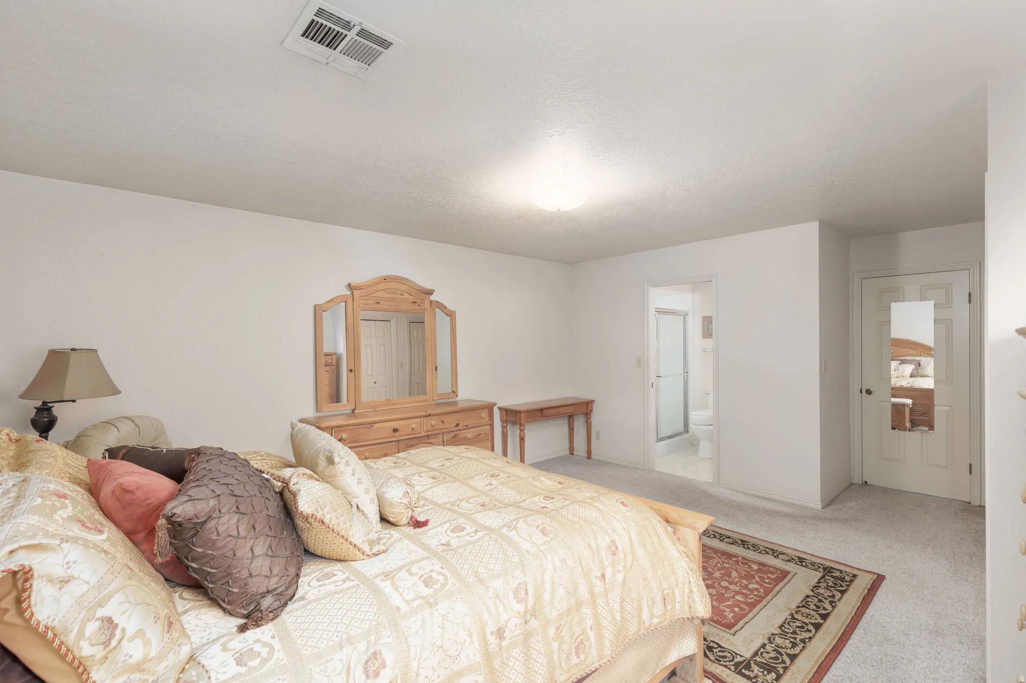 Carpeted flooring, recessed lighting, and a white interior door with frosted glass paneling