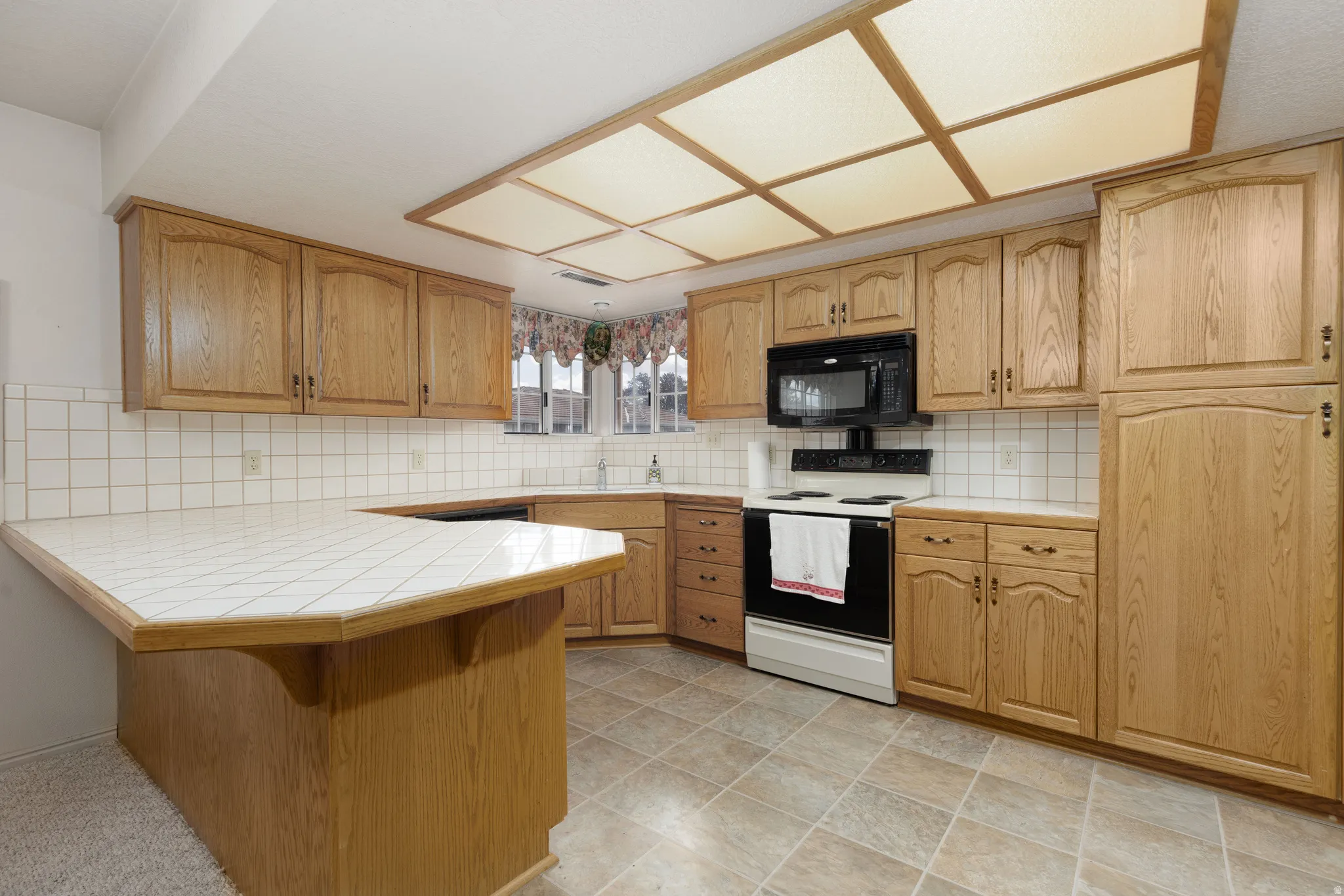 Wood-finish cabinetry with black hardware