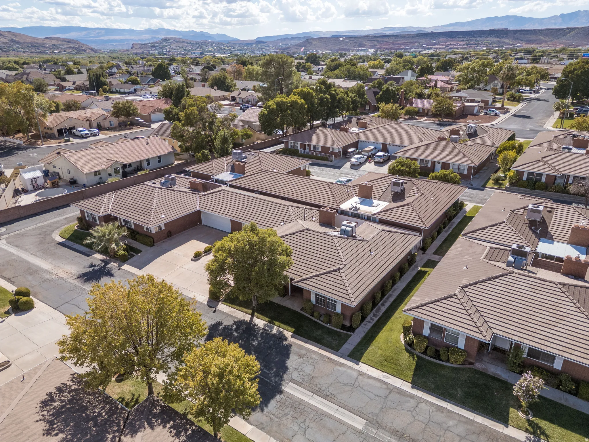 Aerial perspective of a neighborhood featuring residential properties with tile roofs