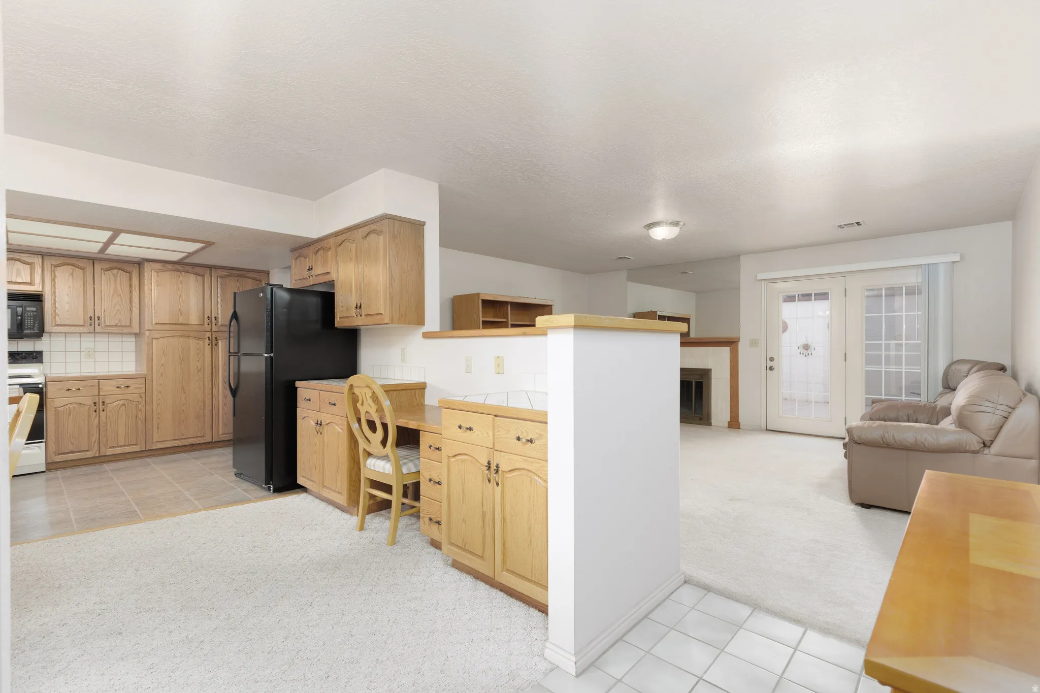 Kitchenette featuring wood cabinetry and tile flooring