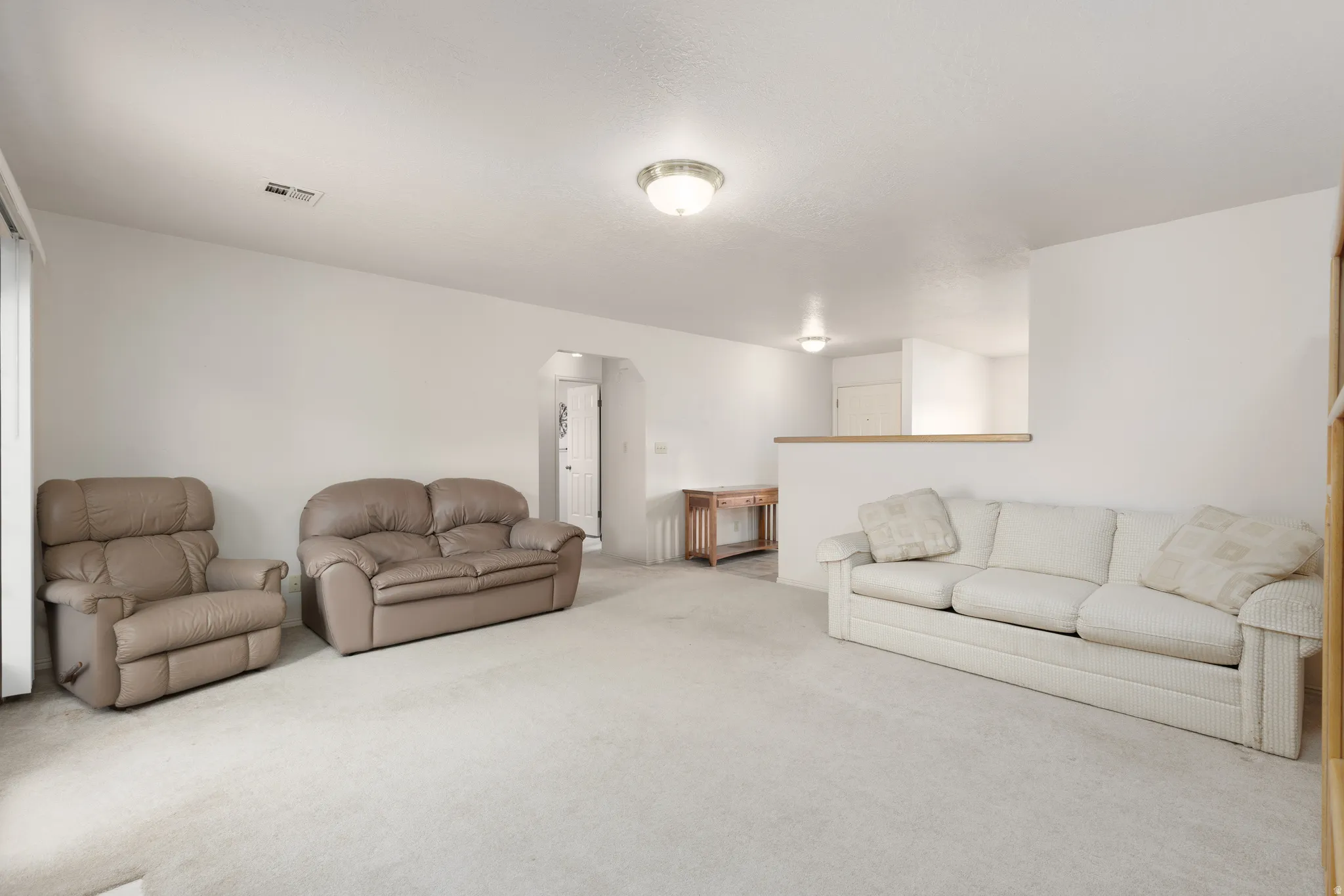Recessed doorway arch with light-colored carpeting throughout