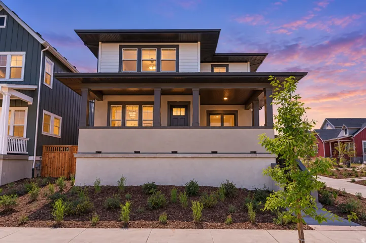 Contemporary exterior with a covered porch, dark trim accents, and multiple windows