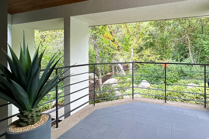 Balcony with black metal railings and tiled flooring