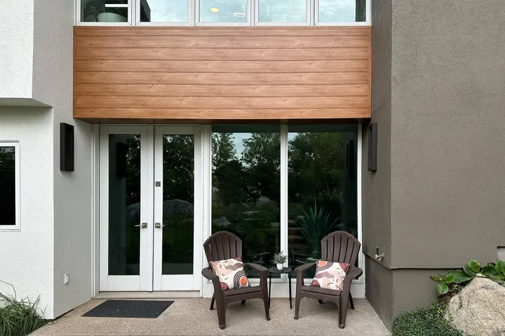 Contemporary facade featuring wood-finish paneling and stucco