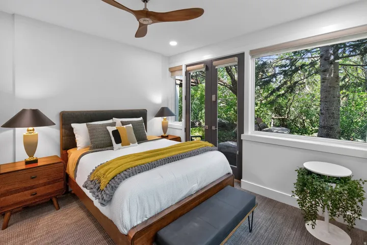 Recessed lighting, wood-finish ceiling fan, full-height glass doors, and expansive floor-to-ceiling window