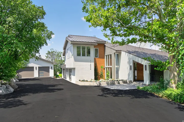 Contemporary exterior with a white stucco finish and wood-panel accents
