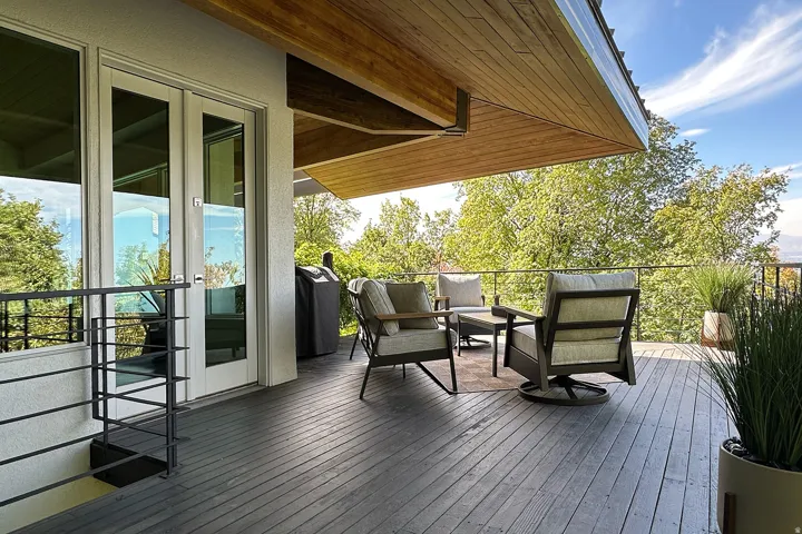Expansive outdoor deck featuring wood-finish flooring and a partial wood-paneled ceiling