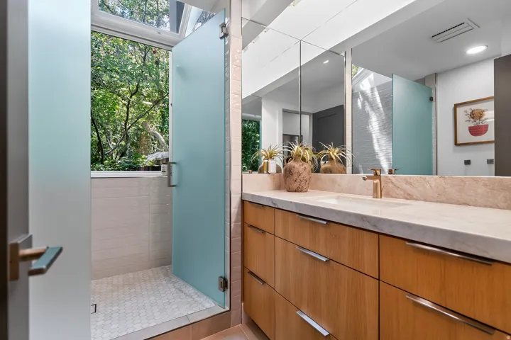 Hardwood vanity with integrated sink and brass-finish faucet