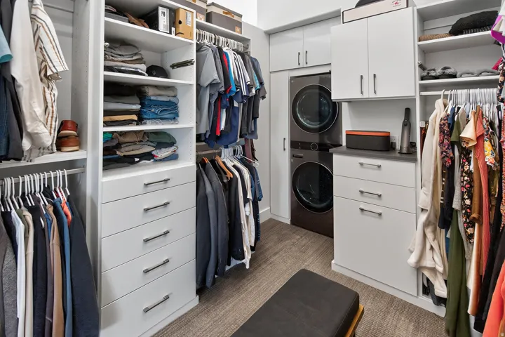 Custom closet system featuring built-in shelving, integrated drawers, and hanging rods