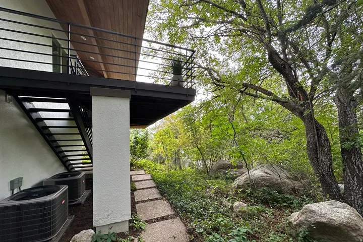 Exterior balcony with wood-finish soffit and sleek black railings