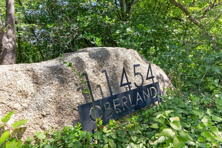 Natural stone boulder with custom metal address signage