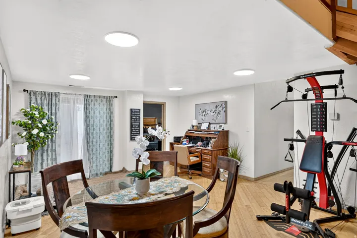 Recessed ceiling lighting, wood-finish flooring, and a built-in wood staircase