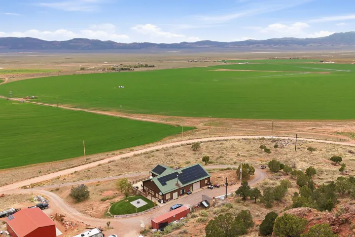 Building with a dark green roof and solar panels