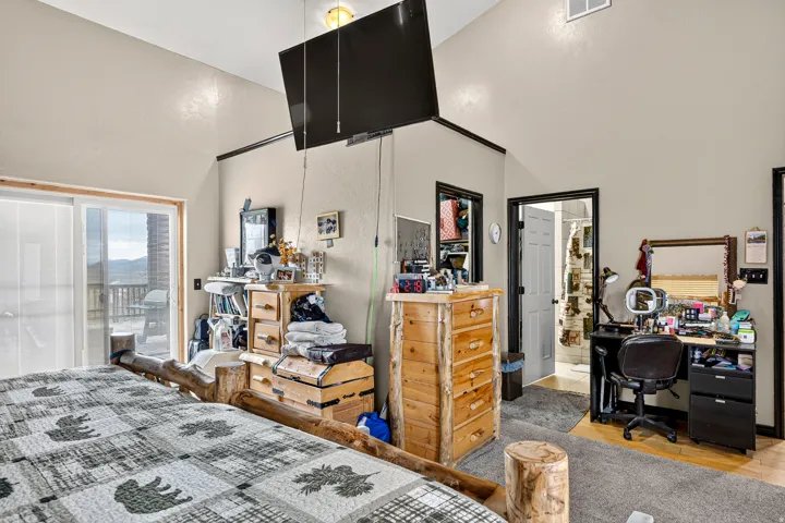 Vaulted ceilings, sliding glass door leading to an outdoor deck, recessed lighting, and wood-finish door frames