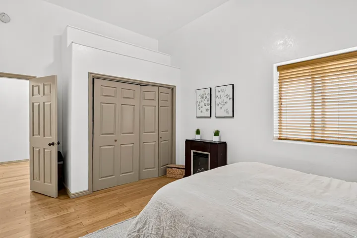 Hardwood-finish flooring, built-in bi-fold closet doors, recessed ceiling lighting, and window blinds