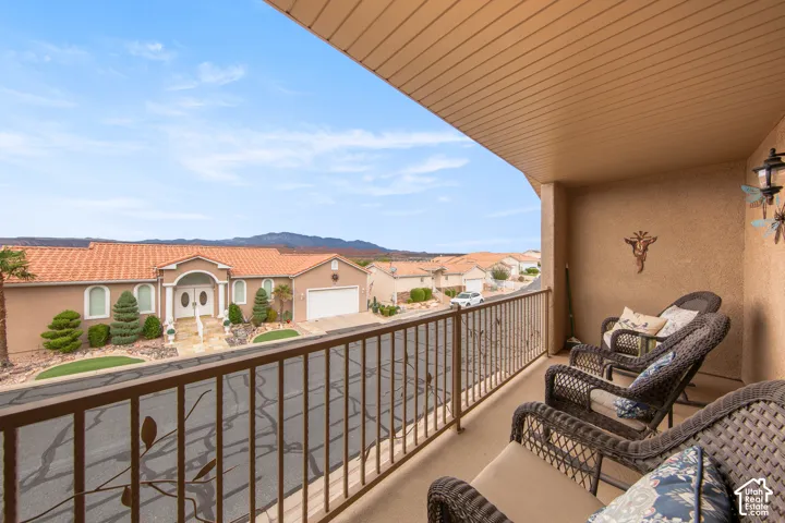 Outdoor balcony with a solid railing and textured exterior finish