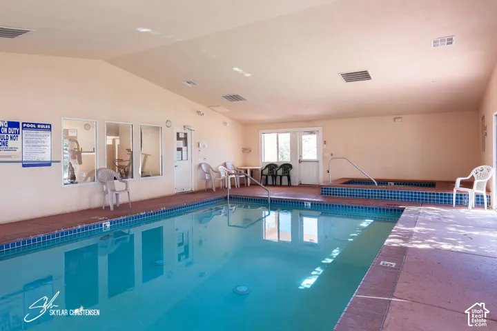 Indoor swimming pool with blue tile surround and integrated spa