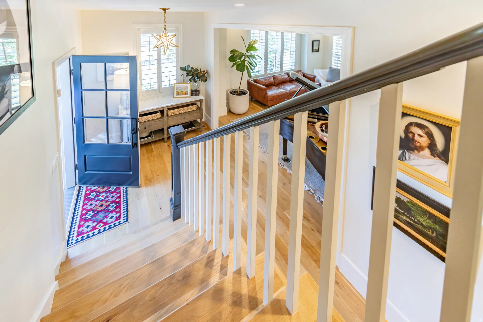 Hardwood stairs with painted risers and a dark wood handrail